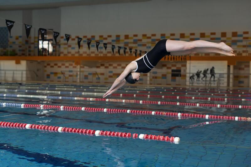 A swimmer diving into the pool